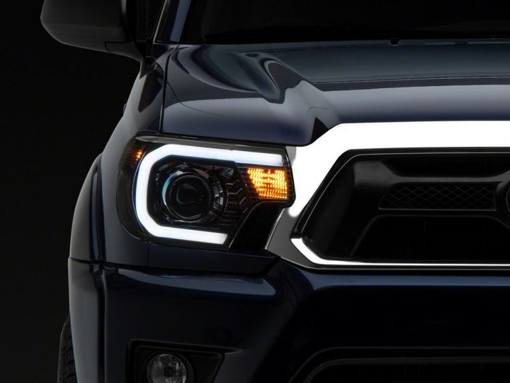 Raxiom 12-15 Toyota Tacoma Axial Series Projector Headlights w/ LED Bar- Black Housing (Clear Lens)