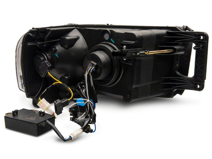 Raxiom 02-05 Dodge RAM 1500 LED Projector Headlights w/ SEQL LED Bar- Black Housing (Clear Lens)