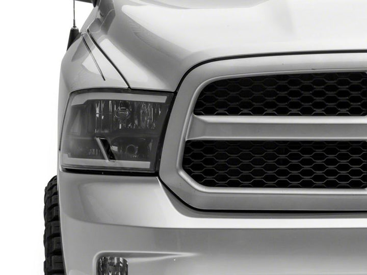Raxiom 09-18 Dodge RAM 1500/2500/3500 Axial Series Headlights w/ LED Bar- Black Housing (Clear Lens)