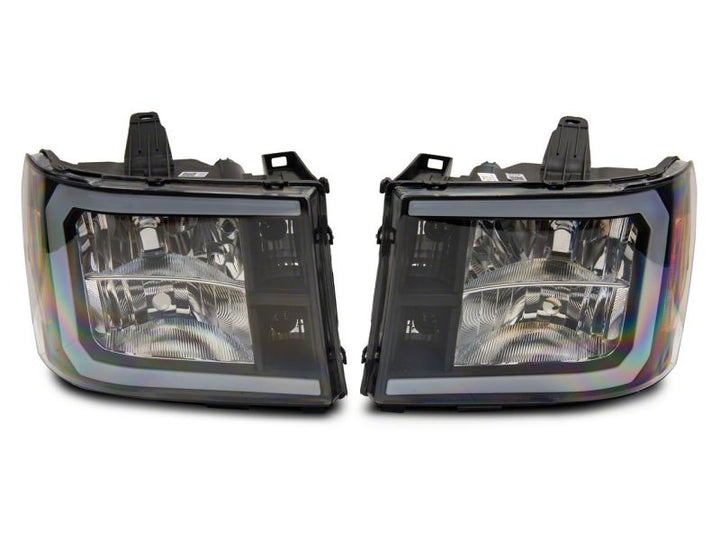 Raxiom 07-13 GMC Sierra 1500 Axial Series Headlights w/ LED Bar- Black Housing (Clear Lens)