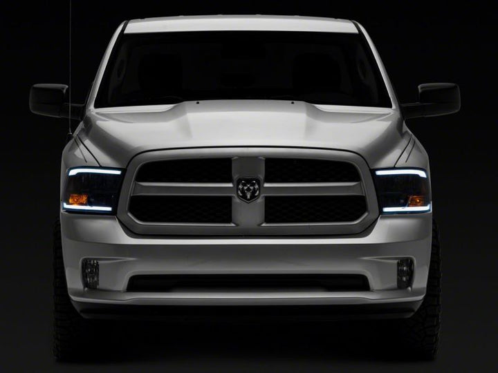 Raxiom 09-18 Dodge RAM 1500/2500/3500 Axial Series Headlights w/ LED Bar- Black Housing (Clear Lens)