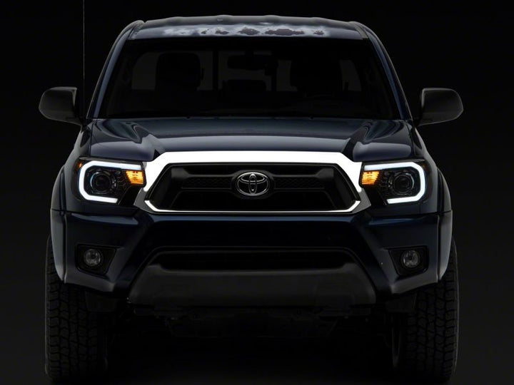 Raxiom 12-15 Toyota Tacoma Axial Series Projector Headlights w/ LED Bar- Black Housing (Clear Lens)