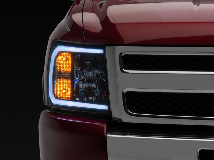 Raxiom 07-13 Chevrolet Silverado 1500 Axial Headlights w/ SEQL LED Bar- Black Housing (Clear Lens)
