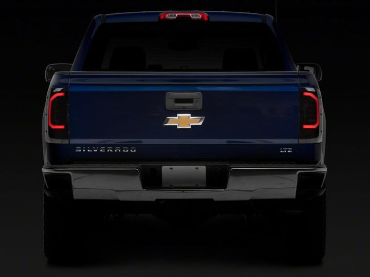 Raxiom 14-18 Chevrolet Silverado 1500 Axial Series LED Tail Lights- Black Housing (Smoked Lens)