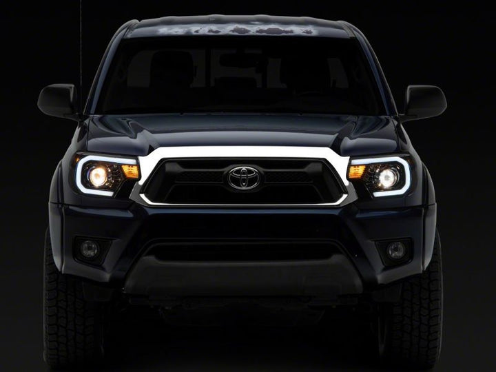 Raxiom 12-15 Toyota Tacoma Axial Series Projector Headlights w/ LED Bar- Black Housing (Clear Lens)
