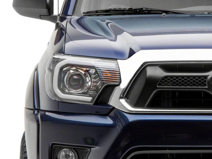 Raxiom 12-15 Toyota Tacoma Axial Series Projector Headlights w/ LED Bar- Black Housing (Clear Lens)