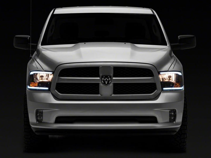 Raxiom 09-18 Dodge RAM 1500/2500/3500 Axial Series Headlights w/ LED Bar- Black Housing (Clear Lens)