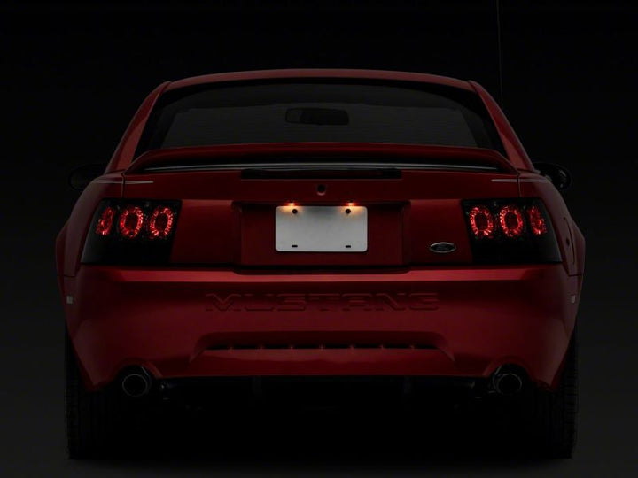 Raxiom 99-04 Ford Mustang Axial Series Altezza Style Tail Lights- Black Housing (Smoked Lens)