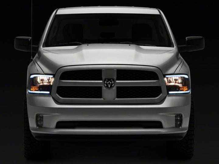Raxiom 09-18 Dodge RAM 1500/2500/3500 Axial Headlights w/ SEQL LED Bar- Black Housing (Clear Lens)