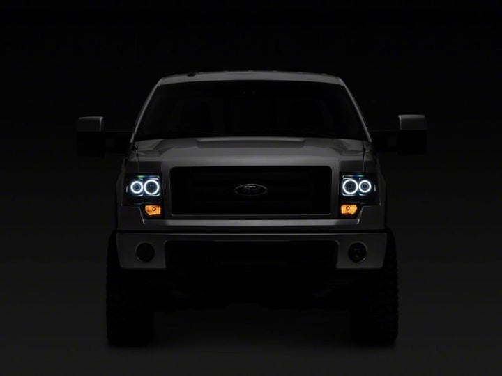 Raxiom 09-14 Ford F-150 Super White LED Halo Projector Headlights- Black Housing (Clear Lens)