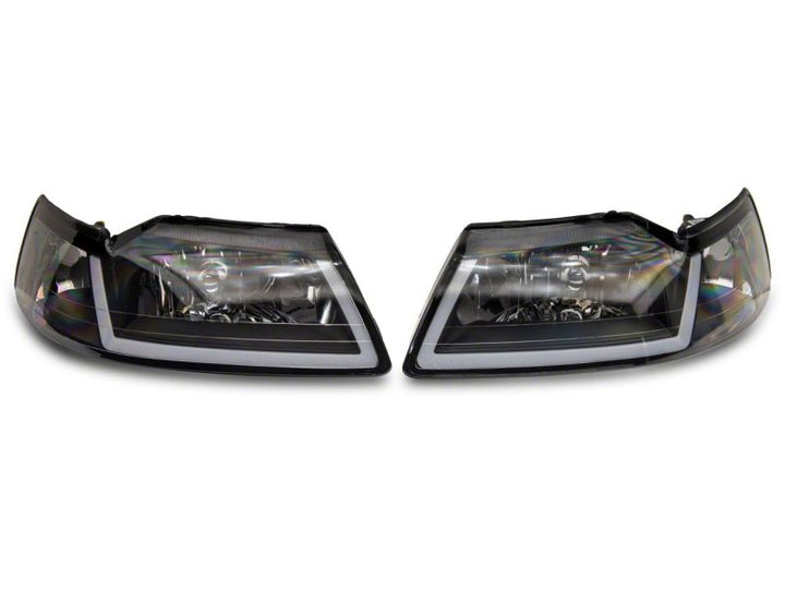 Raxiom 99-04 Ford Mustang Axial Series Headlights w/ Sequential LED Bar- Black Housing (Clear Lens)