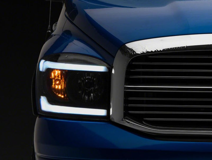 Raxiom 06-09 Dodge RAM 1500/2500/3500 Axial Headlights w/ SEQL LED Bar- Black Housing (Clear Lens)