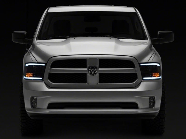 Raxiom 09-18 Dodge RAM 1500/2500/3500 Axial Headlights w/ SEQL LED Bar- Black Housing (Clear Lens)