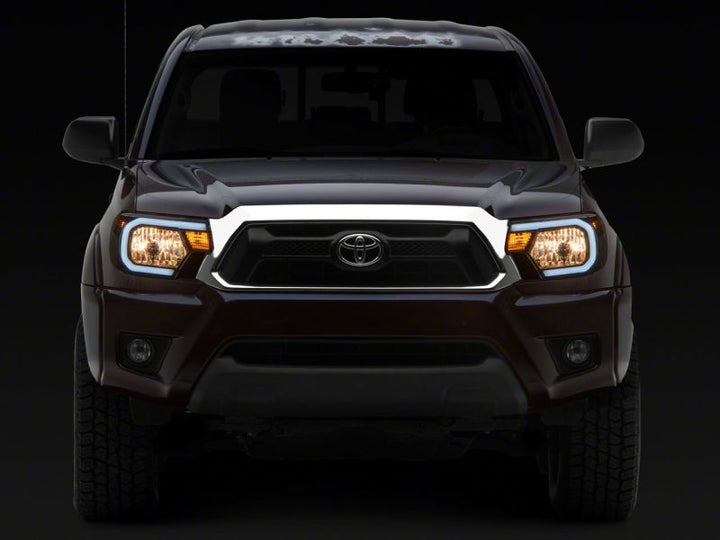 Raxiom 12-15 Toyota Tacoma Axial Series Headlights w/ LED Bar- Black Housing (Clear Lens)